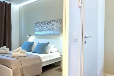 a bedroom with a bed with blue pillows at Castellammare Residence in Palermo