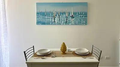 a table with a glass of water on a table at Castellammare Residence in Palermo