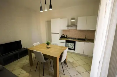 a kitchen with a wooden table and white cabinets at appartamento san felice in Bagheria