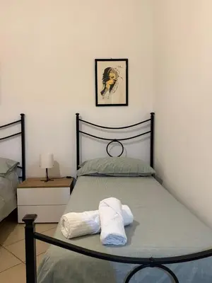 a bedroom with a bed with two towels on it at appartamento san felice in Bagheria