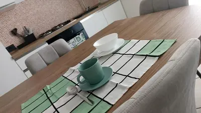 a dining room table with a green cup on it at appartamento san felice in Bagheria