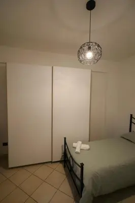 a bedroom with a bed and a light at appartamento san felice in Bagheria