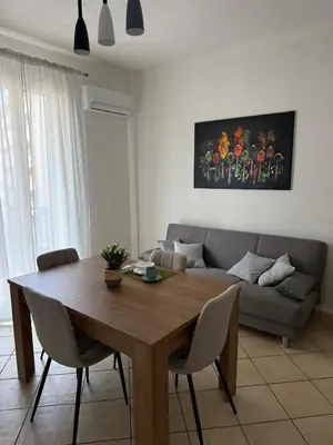 a living room with a wooden table and a couch at appartamento san felice in Bagheria