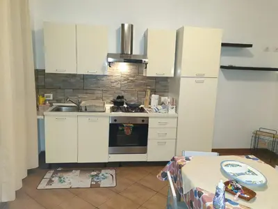 a kitchen with white cabinets and a stove at CASA di VIA PITRE' 29 in Palermo