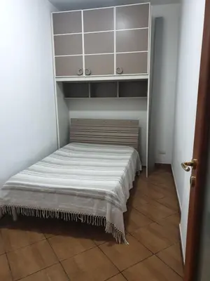a bed in a small room with white cabinets at CASA di VIA PITRE' 29 in Palermo