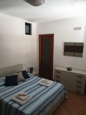 a bedroom with a bed and a dresser with towels on it at CASA di VIA PITRE' 29 in Palermo