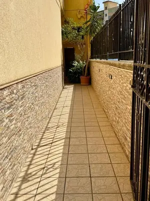 a walkway leading to a building with a fence at Piccolo Brasile Home in Capaci