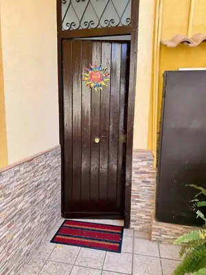 a wooden door with a colorful sticker on it at Piccolo Brasile Home in Capaci
