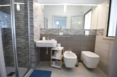 a bathroom with a sink and a toilet and a shower at ammare da mari in Castellammare del Golfo