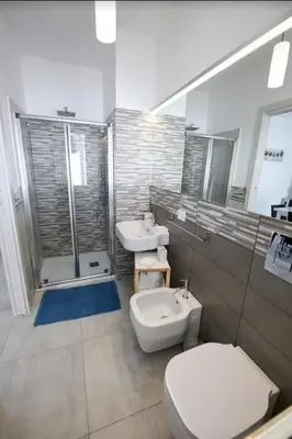 a bathroom with two sinks and a toilet and a shower at ammare da mari in Castellammare del Golfo