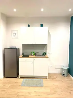 a kitchen with a sink and a refrigerator at Toselli 32 in Palermo