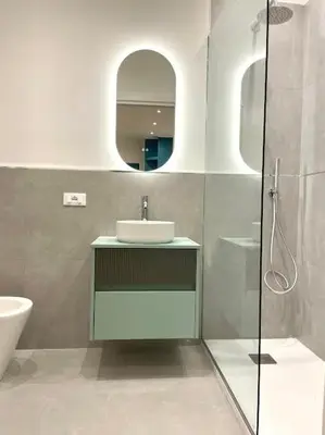 a bathroom with a sink and a glass shower at Toselli 32 in Palermo