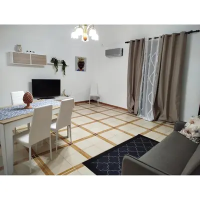 a living room with a tv on a white wall at Ocean's Holiday House in Terrasini