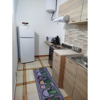 a small kitchen with a stove and a sink at Ocean's Holiday House in Terrasini