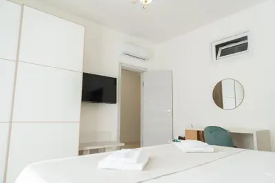 a white room with a table and a mirror at Light Charme, Sun Light Apartment a due passi dalla PIAZZA DUOMO in Terrasini