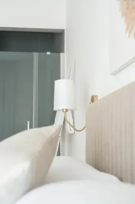 a bedroom with a bed with a lamp on it at Light Charme, Sun Light Apartment a due passi dalla PIAZZA DUOMO in Terrasini