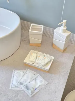a bathroom with a sink and a toilet and two boxes at Light Charme, Sun Light Apartment a due passi dalla PIAZZA DUOMO in Terrasini