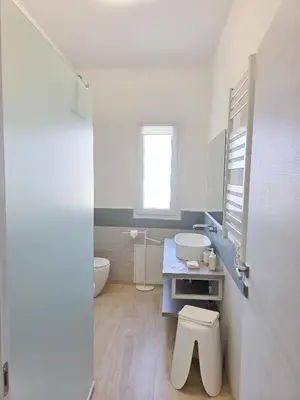 a white bathroom with a sink and a toilet at Light Charme, Sun Light Apartment a due passi dalla PIAZZA DUOMO in Terrasini