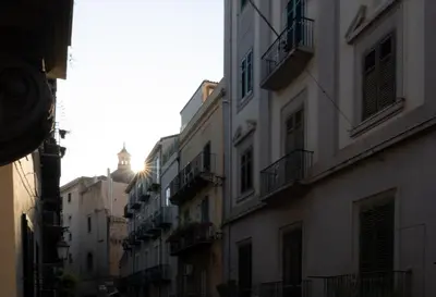 a group of buildings with balconies on a street at A Calat'i Jurici in Palermo