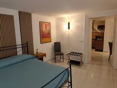 a bedroom with a bed and a table and a chair at A Calat'i Jurici in Palermo
