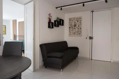 a living room with a couch and a chair at A Calat'i Jurici in Palermo