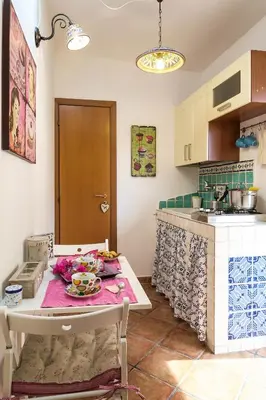 a kitchen with a stove and a sink at Attico Finocchiaro - Terrazza in Centro Wifi Free in Palermo