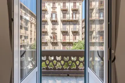a living room with a couch and a dining room table at Casa Markea by Wonderful Italy in Palermo