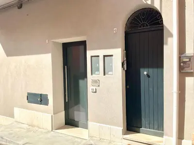 two doors on the side of a building at Due passi dal castello a mare in Castellammare del Golfo
