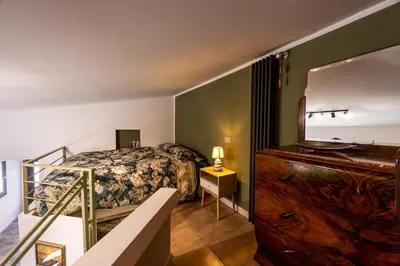 a bedroom with a bed and a dresser with a mirror at Ibis Lodge With Swimming Pool in Palermo