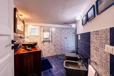 a bathroom with a sink and a toilet and a tub at Ibis Lodge With Swimming Pool in Palermo