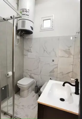 a bathroom with a sink and a toilet and a shower at Teatro Massimo Terrace relax suite in Palermo