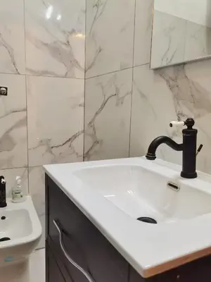 a white bathroom with a sink and a mirror at Teatro Massimo Terrace relax suite in Palermo