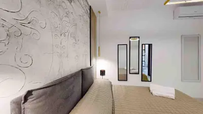 a bedroom with a bed and a wall at Teatro Massimo Terrace relax suite in Palermo