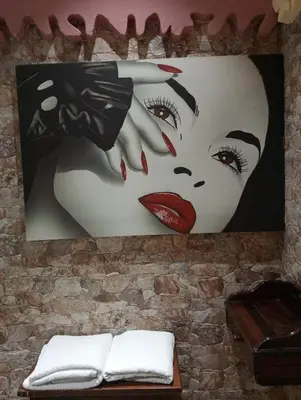 a painting of a woman on a wall at Casa Porta Nuova 1989 in Palermo