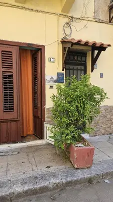 a building with a clock tower in front at Casa Porta Nuova 1989 in Palermo