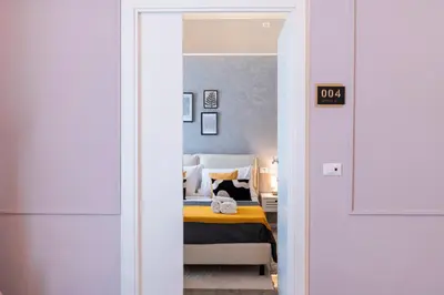 a bedroom with a bed and a mirror at Giardino Segreto - Affitta Camere in Castellammare del Golfo