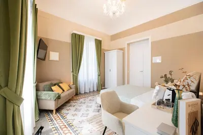 a small room with a bed and a couch at Giardino Segreto - Affitta Camere in Castellammare del Golfo