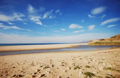 a beach with rocks on the sand and water at Appartamento Citreum in Balestrate