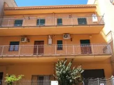an orange building with balconies on the side of it at CASA ARENA - Affitti Brevi in Bagheria