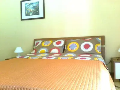a bedroom with a bed with colorful pillows at CASA ARENA - Affitti Brevi in Bagheria