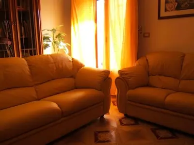 a living room with a couch and a chair at CASA ARENA - Affitti Brevi in Bagheria