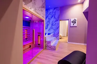 a room with a glass shower with purple lighting at GM Luxury Apartment in Palermo