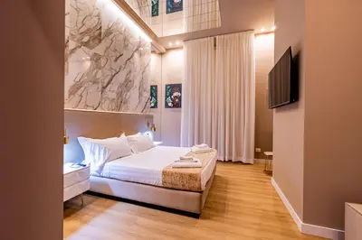 a bedroom with a bed and a flat screen tv at GM Luxury Apartment in Palermo
