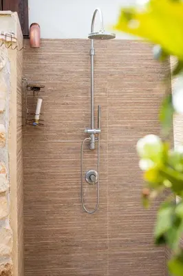 a shower with a hose on a wooden wall at Luxury Hot tub Swimming pool Private pool Wi-Fi BBQ in Castellammare del Golfo