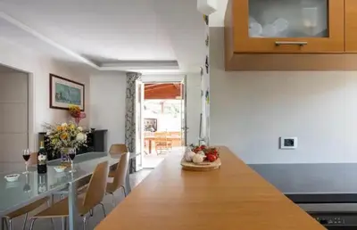 a kitchen with a large wooden table and chairs at Luxury Hot tub Swimming pool Private pool Wi-Fi BBQ in Castellammare del Golfo