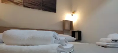 a room with white towels on a bed at Aspranthouse in Aspra