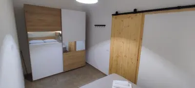 a bathroom with a closet and a door with towels at Aspranthouse in Aspra