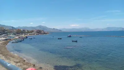 a view of a beach with boats in the water at Aspranthouse in Aspra