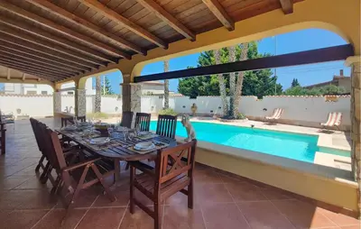 a dining room with a table and a swimming pool at Beautiful Home In Altavilla Milicia in Altavilla Milicia