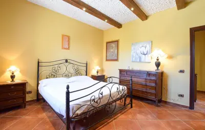 a bedroom with a large bed and two night stands at Beautiful Home In Altavilla Milicia in Altavilla Milicia